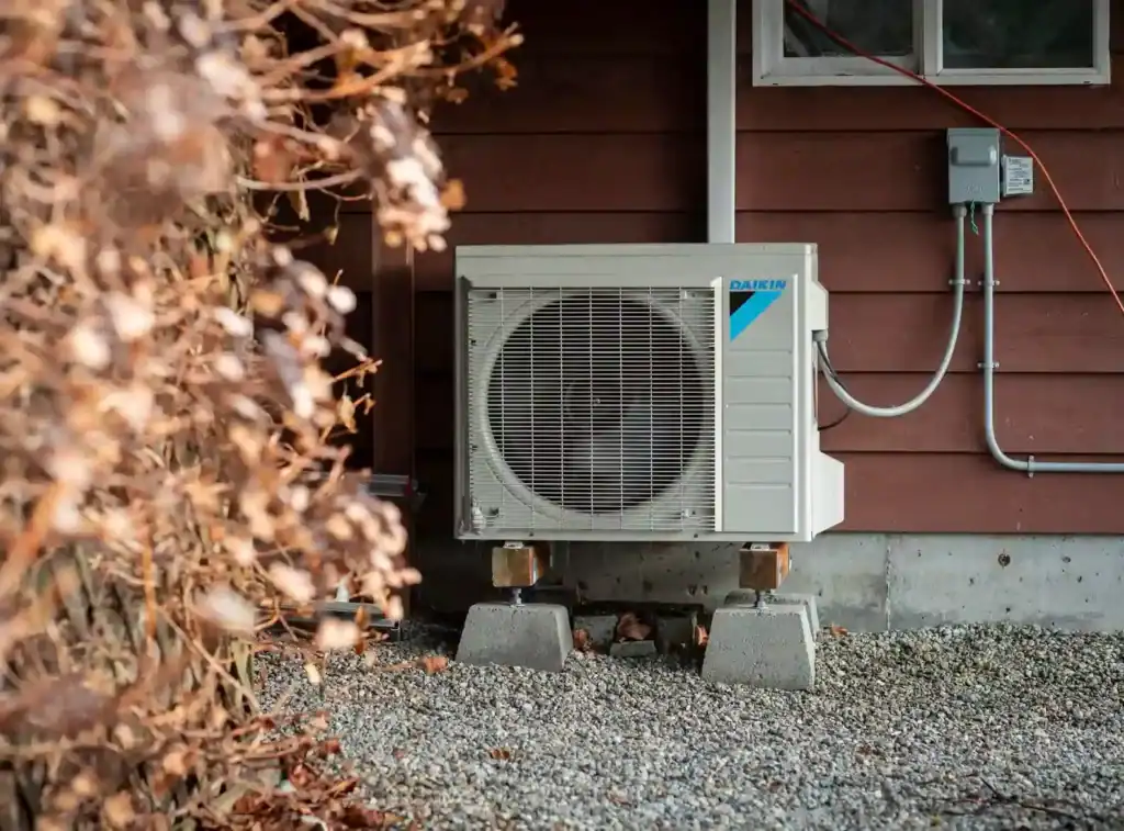 A Daikin heatpump sitting outside of a house